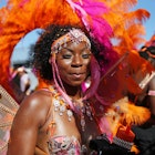 A dancer performs during the the Notting Hill Carnival in west London. (Photo by Hollie Adams/PA Images via Getty Images)
