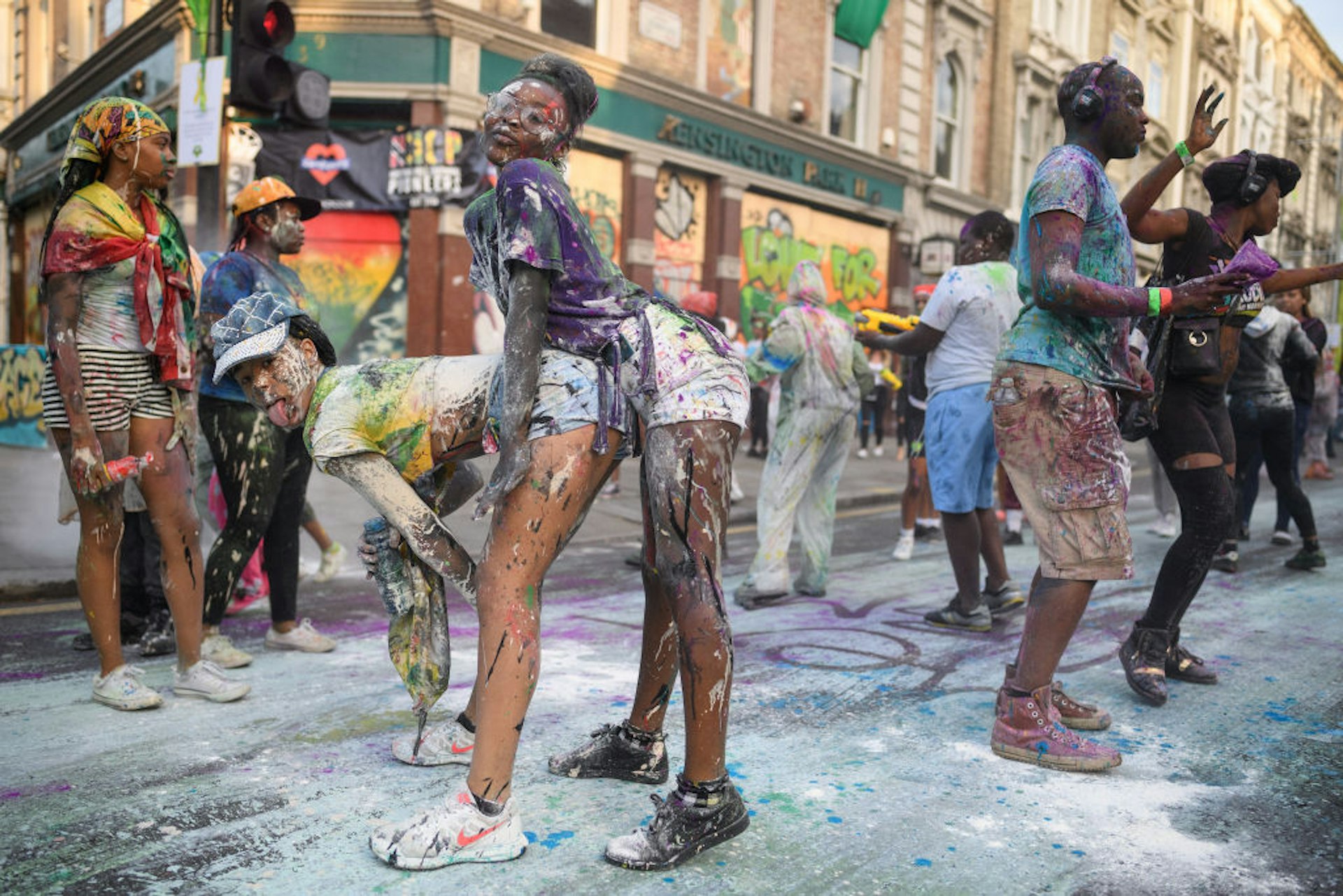 Paint-covered revellers take part in the traditional "J'ouvert" opening parade of the Notting Hill carnival 