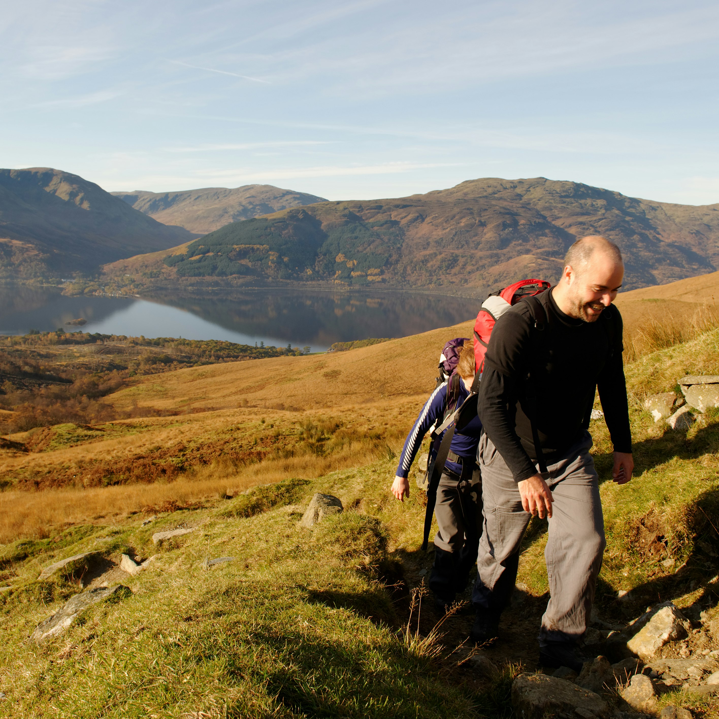 Two young people approaching the summit of Ben Lomond, Scotland, in Autumn