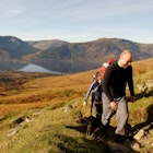 Two young people approaching the summit of Ben Lomond, Scotland, in Autumn