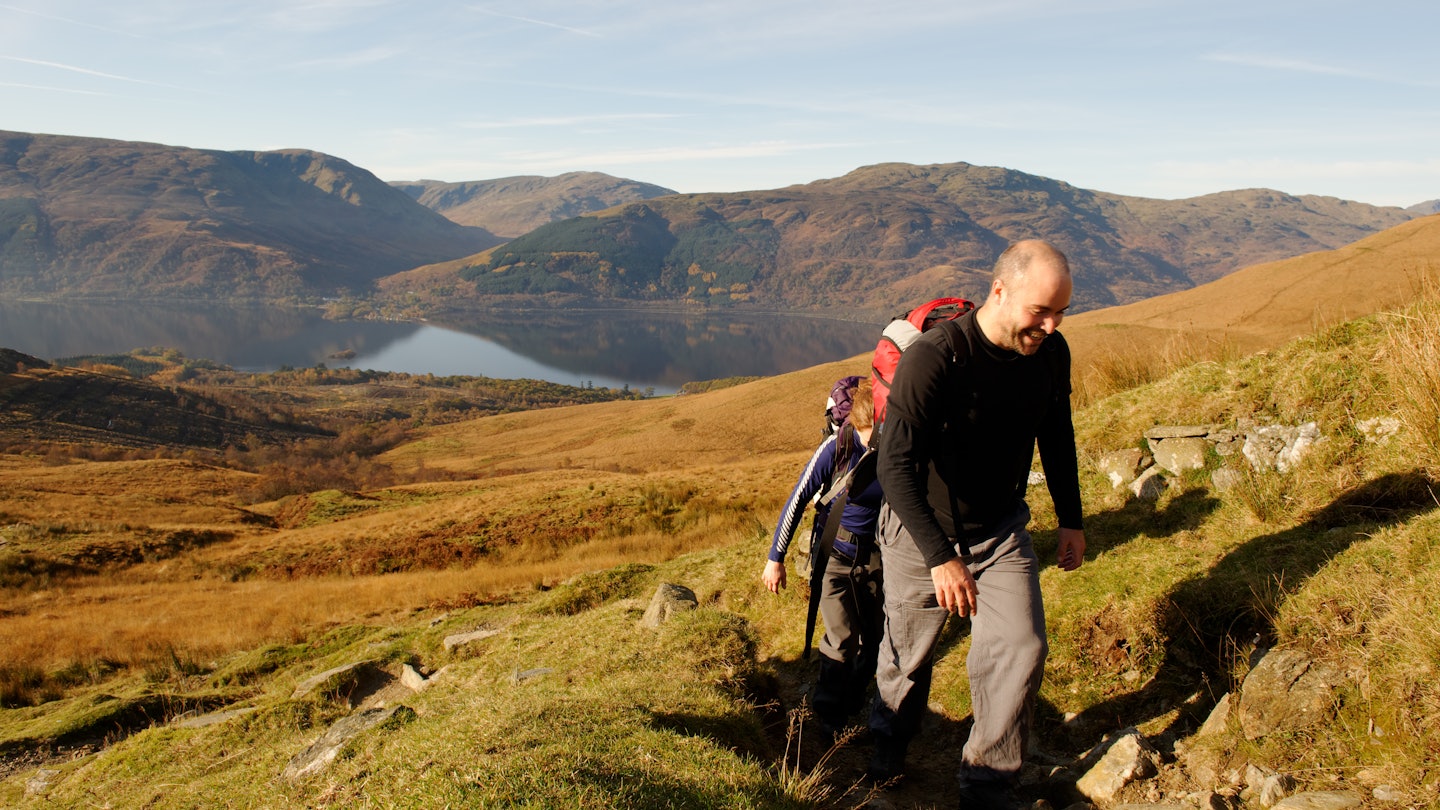 Two young people approaching the summit of Ben Lomond, Scotland, in Autumn