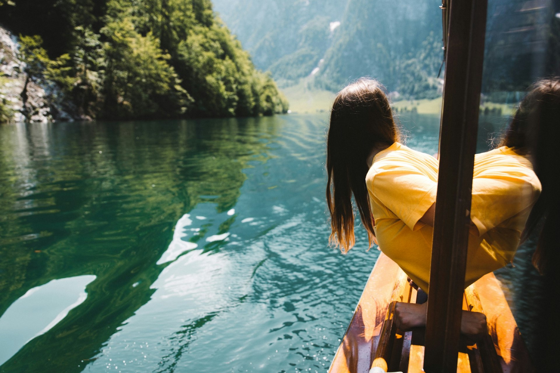Woman enjoying a view of lake Konigsee from ferry boat