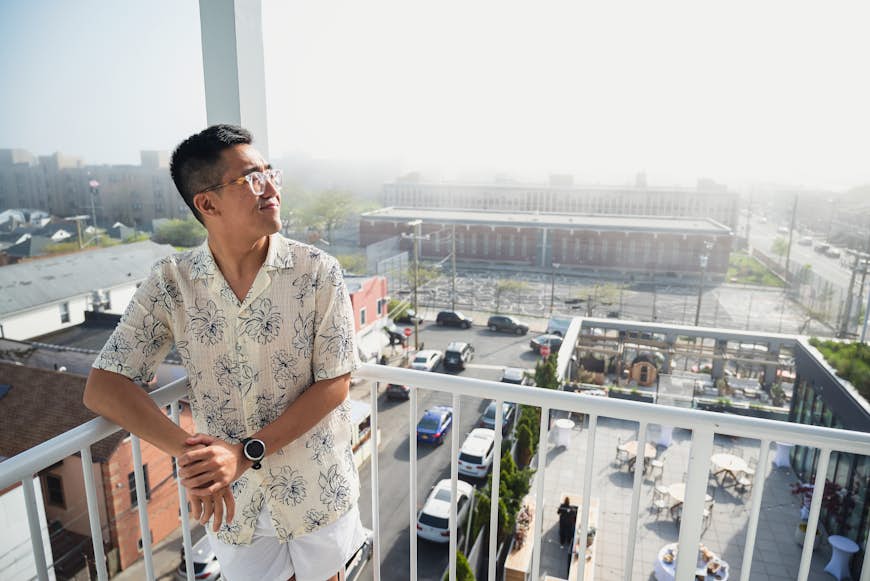 Chris Dong on his hotel room's balcony, Rockaway Hotel