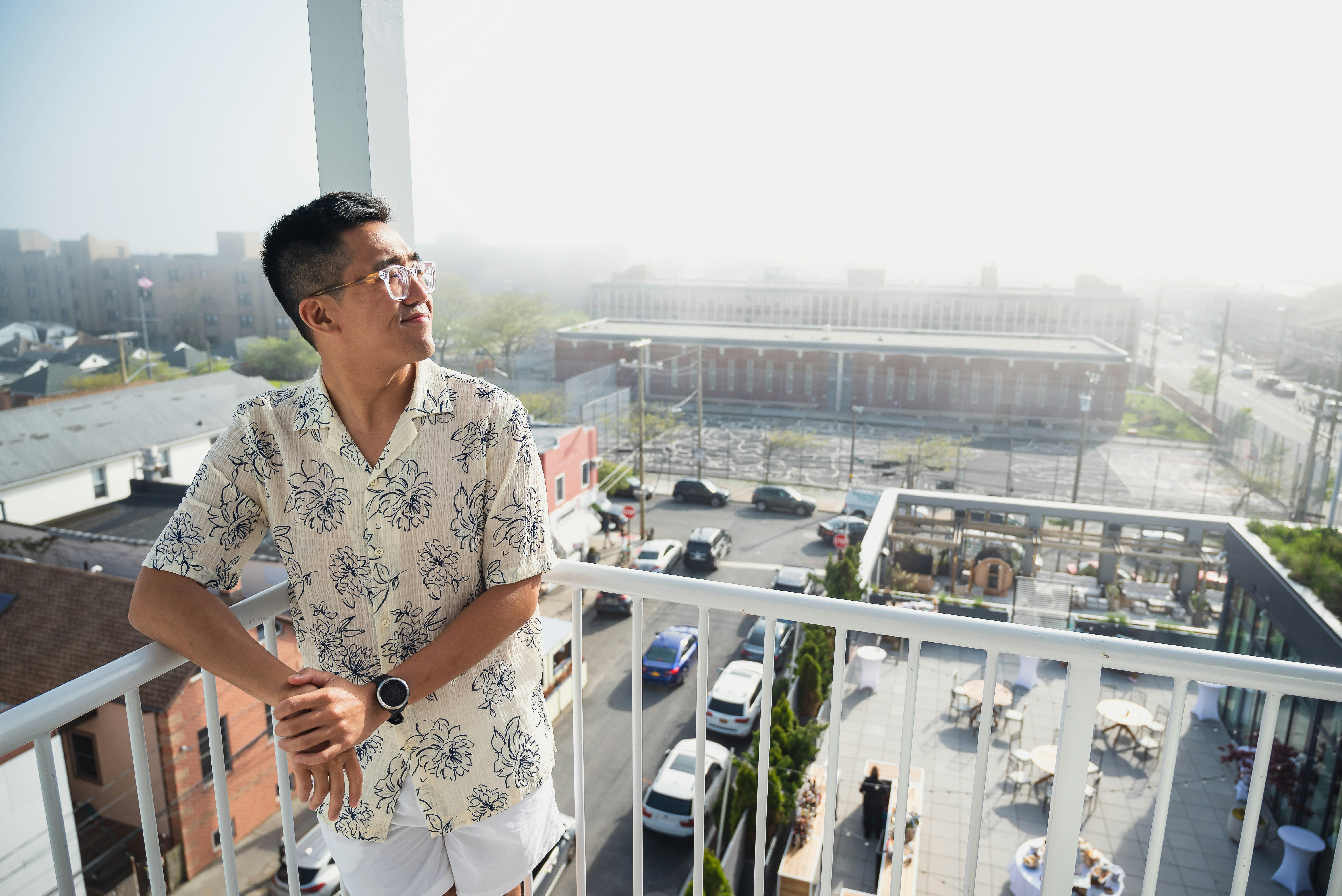 Chris Dong on his hotel room's balcony, Rockaway Hotel
