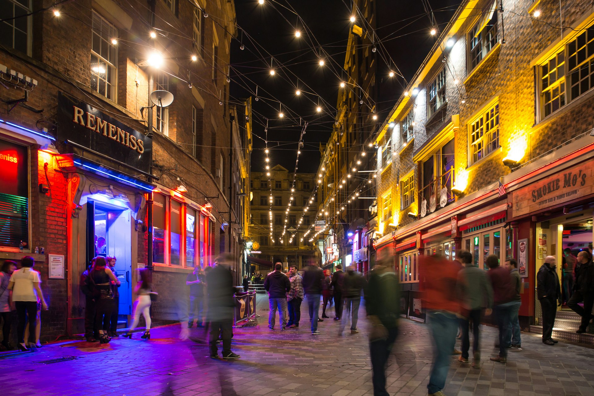Blurred people walking on Mathew Street in Liverpool at night