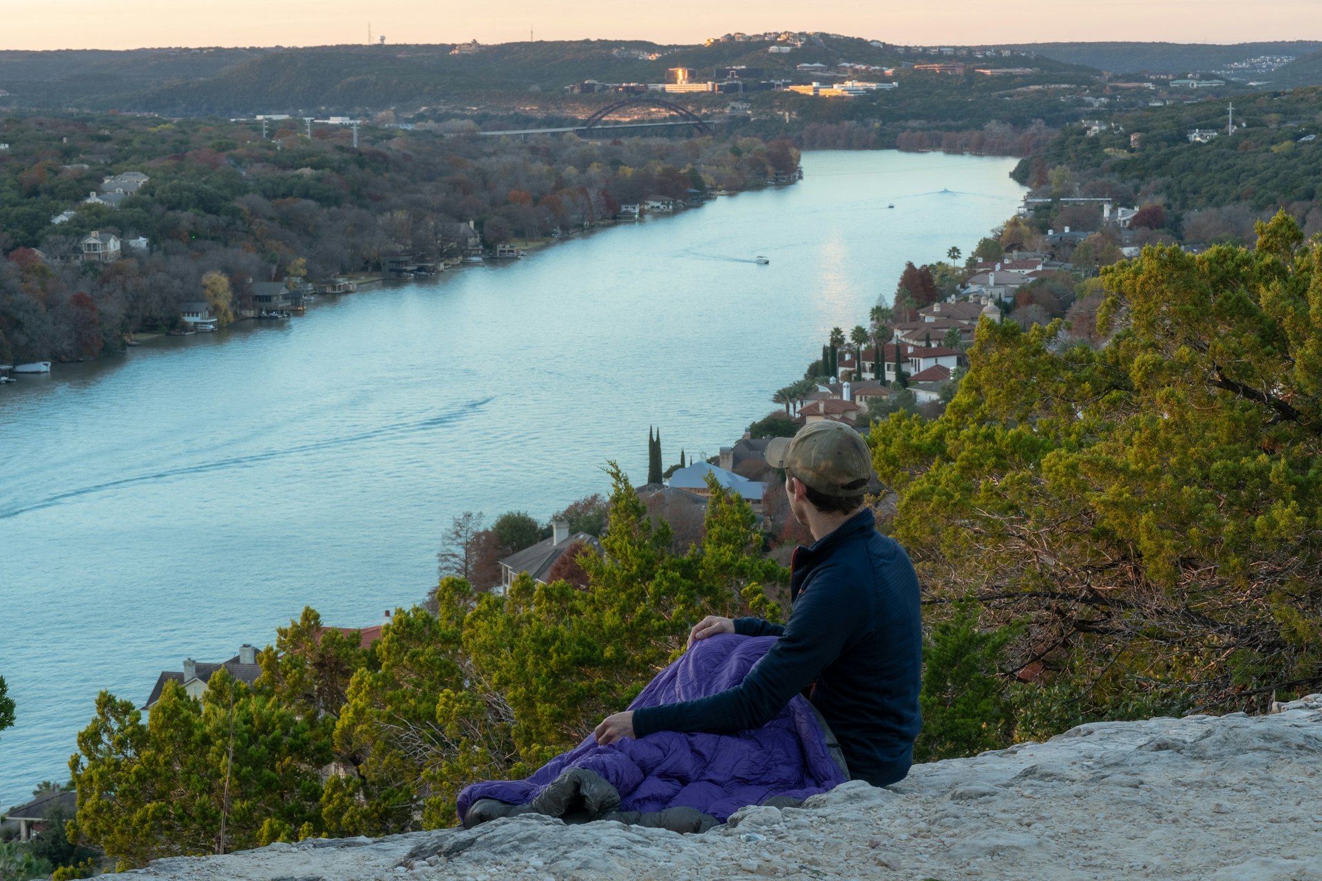 A man catching sunset at Mount Bonnell in Austin