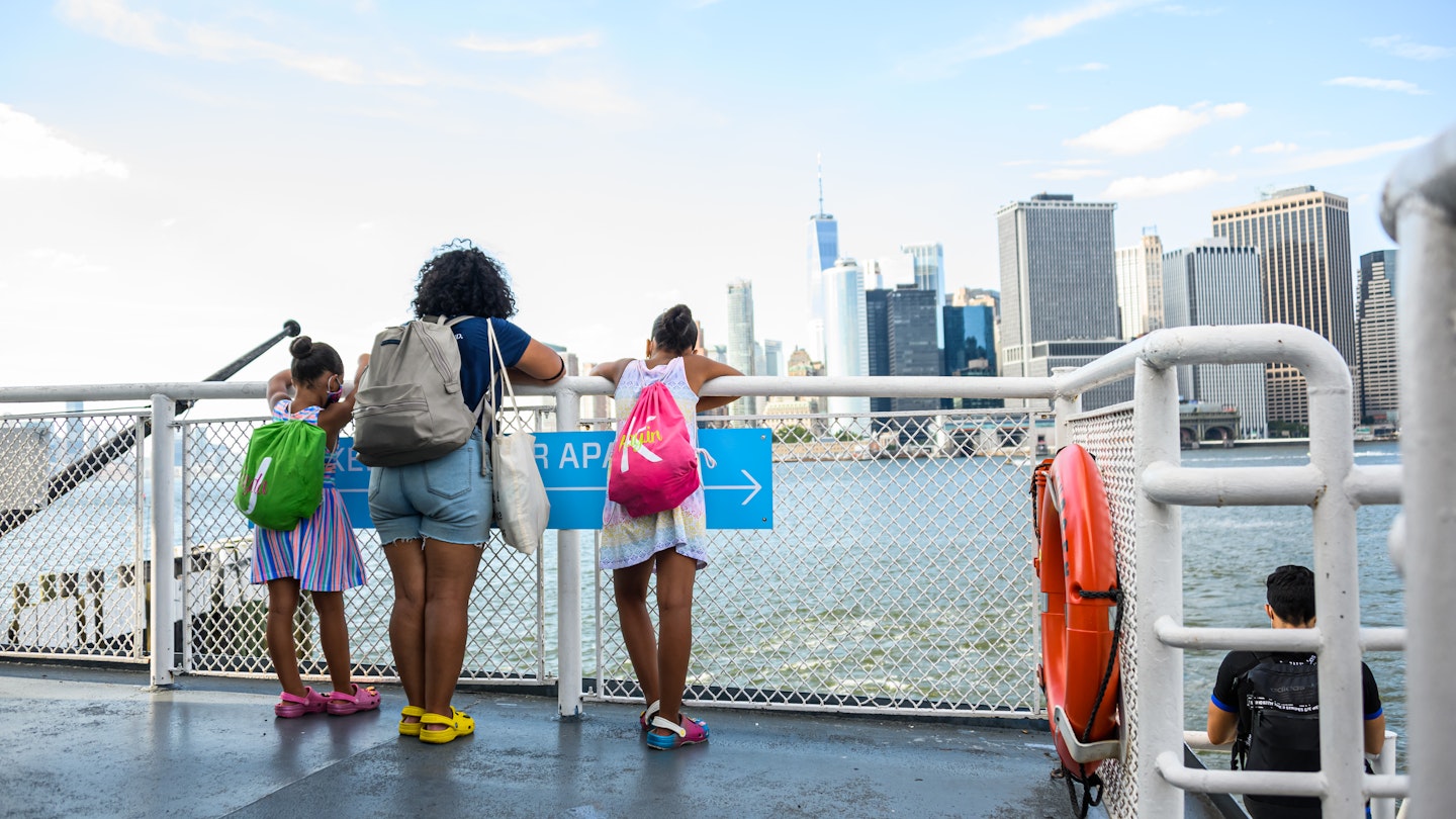 NEW YORK, NEW YORK - JULY 20: People look at the view from the Governors Island Ferry as the city enters Phase 4 of re-opening following restrictions imposed to slow the spread of coronavirus on July 20, 2020 in New York City. The fourth phase allows outdoor arts and entertainment, sporting events without fans and media production. (Photo by Noam Galai/Getty Images)