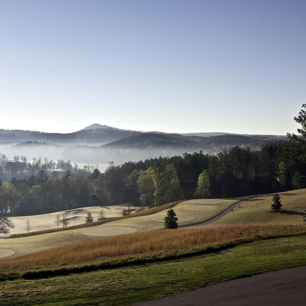 Early morning light pierces the mist and spreads across the Blue Ridge foothills.