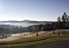 Early morning light pierces the mist and spreads across the Blue Ridge foothills.