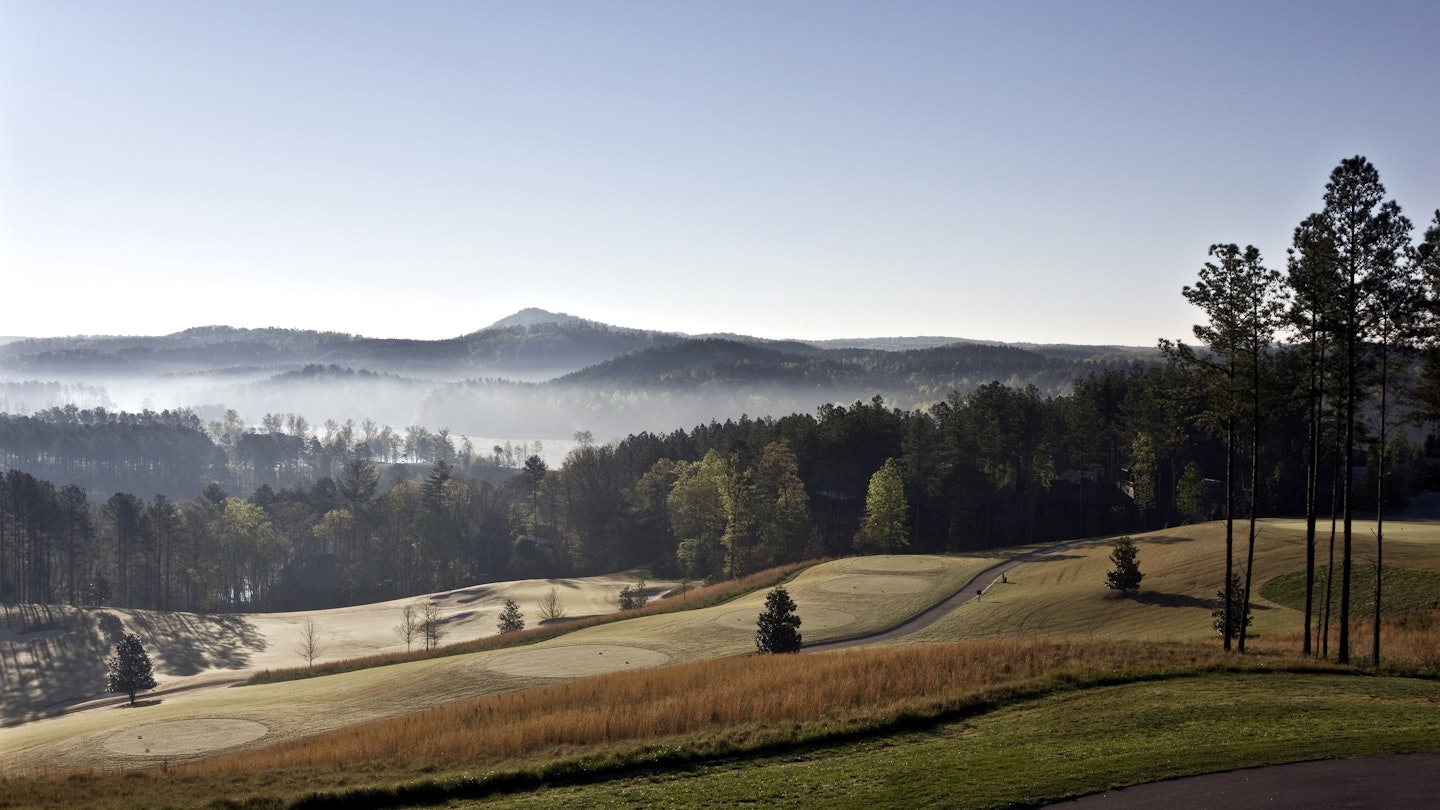 Early morning light pierces the mist and spreads across the Blue Ridge foothills.