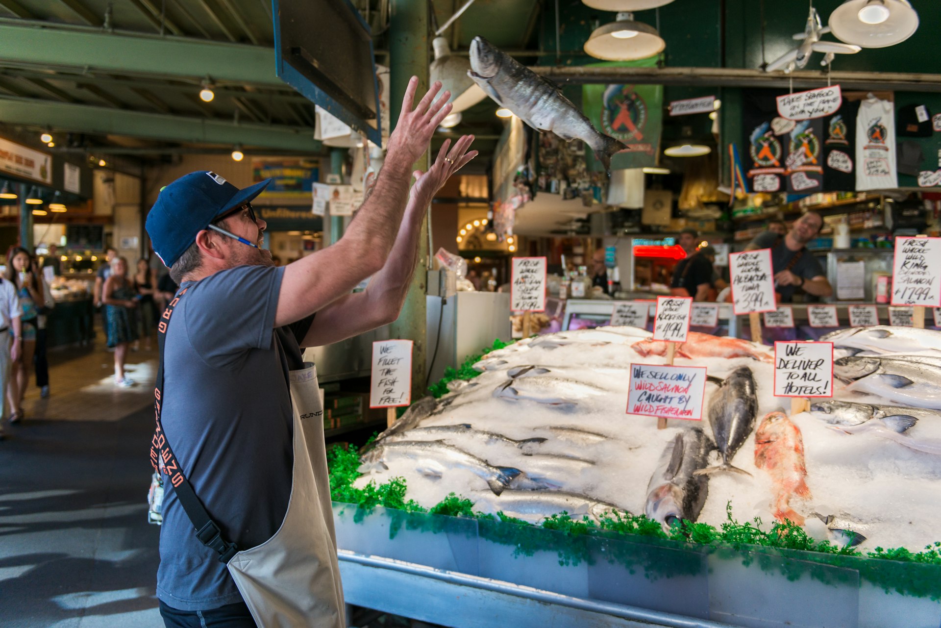 Fish monger tosses a fish at a stall at Pike Place Market