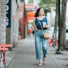 A fashionable Hispanic woman walks the sidewalks of West Seattle, window shopping and enjoying some personal time.  Shot in Seattle, Washington, USA.