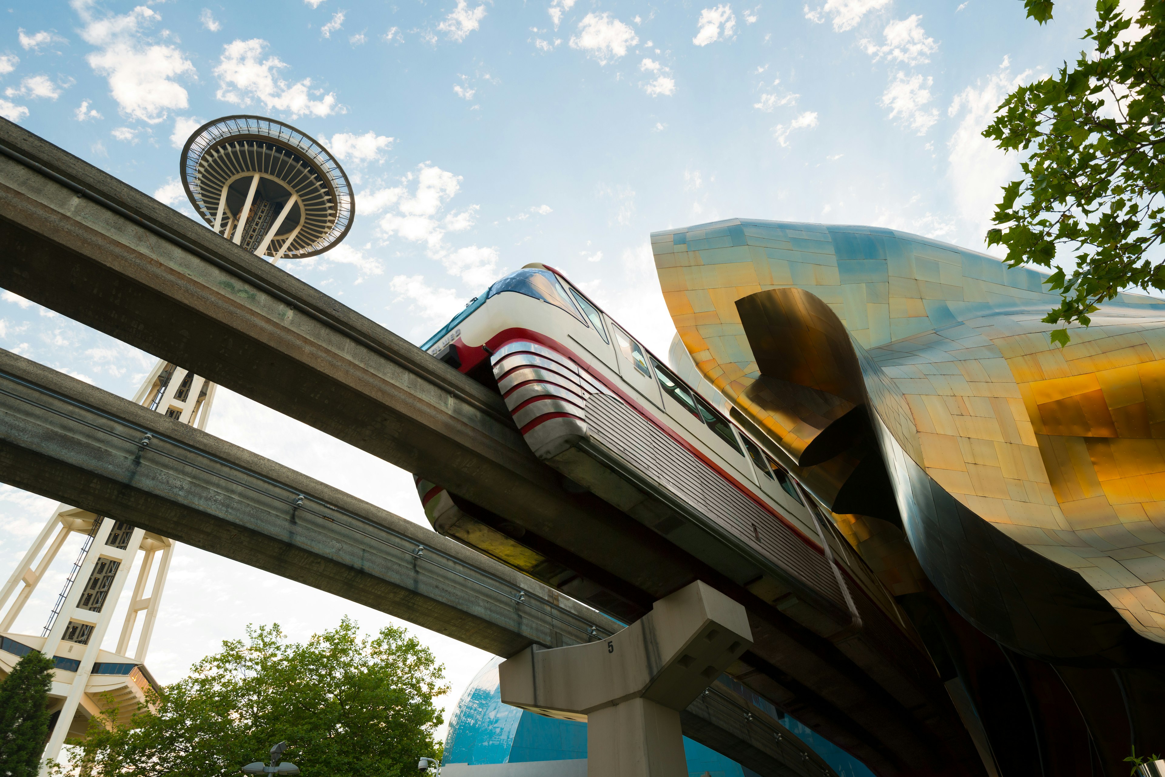 A monorail train running on a raised line through a city