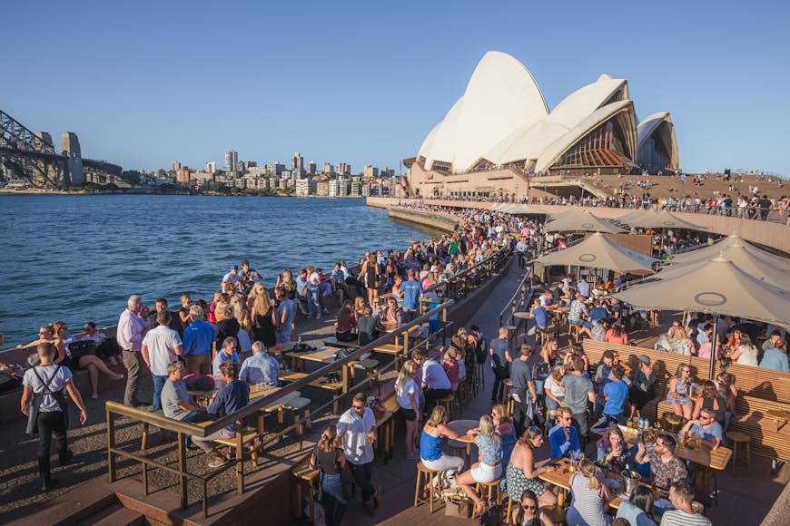 A busy Sydney Harbour leading up to the Opera House as both locals and tourists alike enjoy some drinks and socializing at Opera Bar.