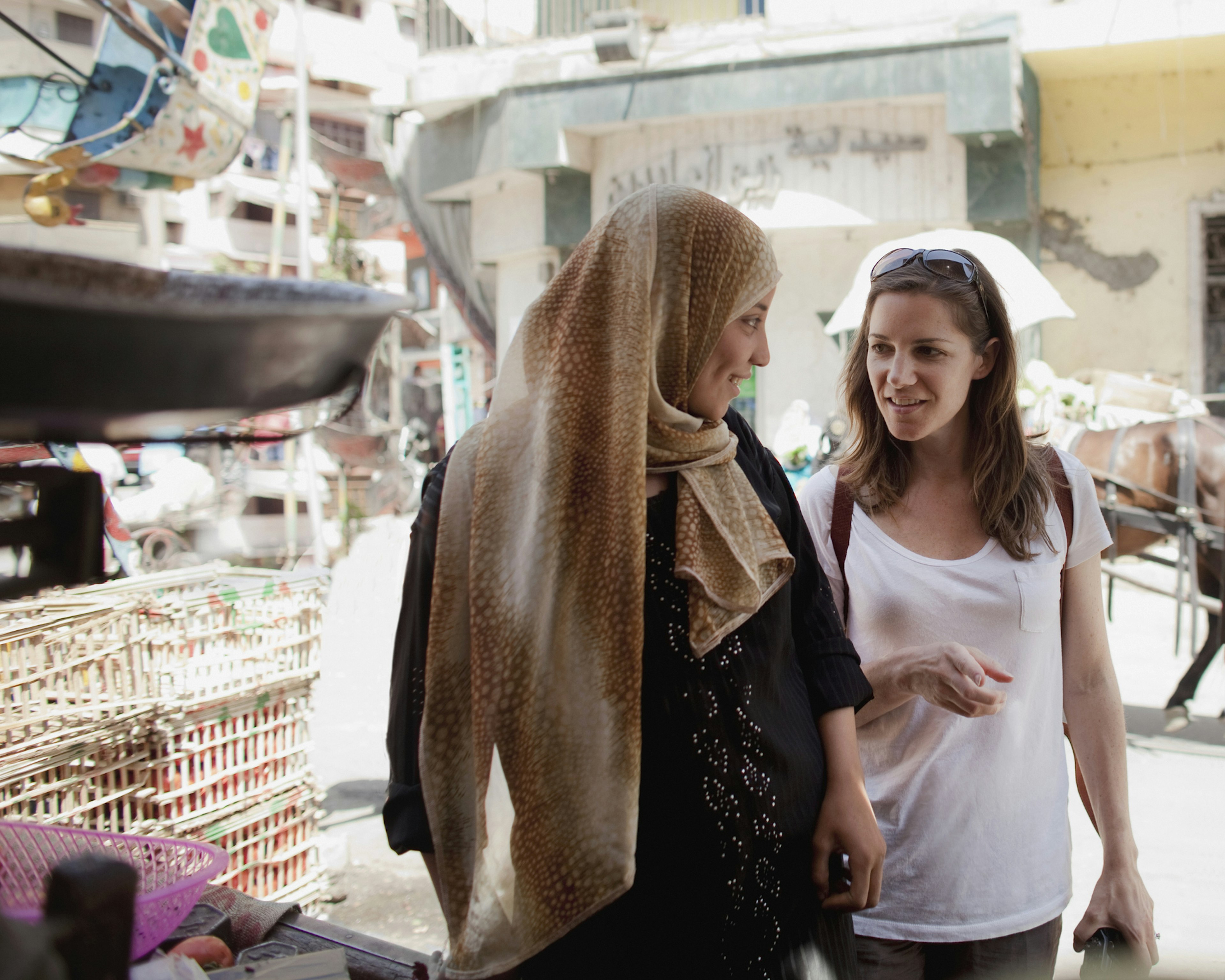 Two women talking in a market in Egypt