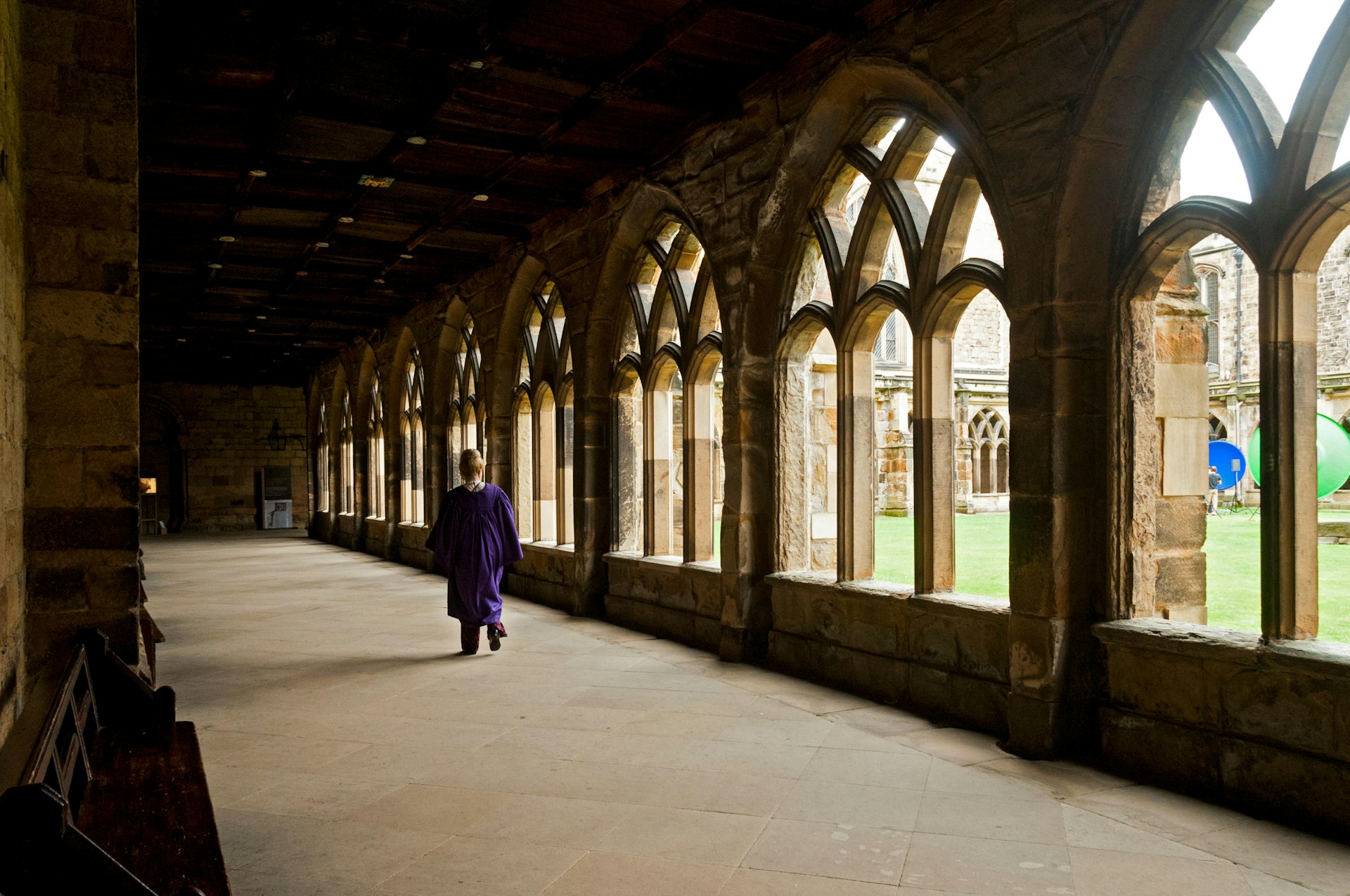 A person walks down a corridor in the cloisters of Durham Cathedral, Durham, England, United Kingdom