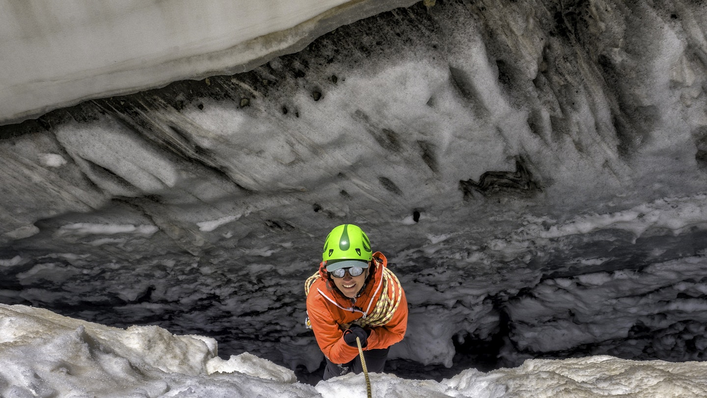 France, Ecrins Alps, Dauphine, woman on rope in crevice