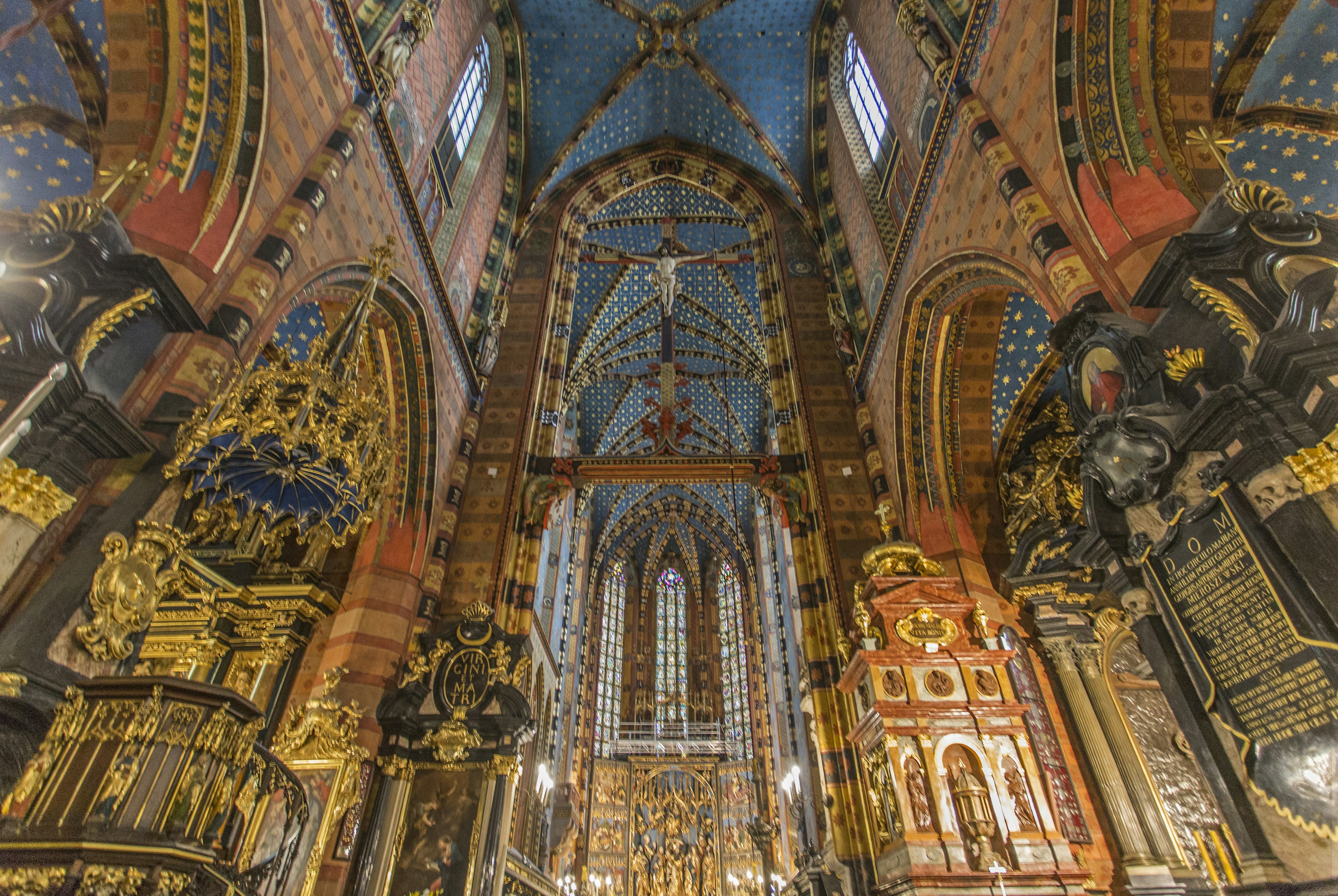 View inside a large church with ornate ceilings, windows and arches