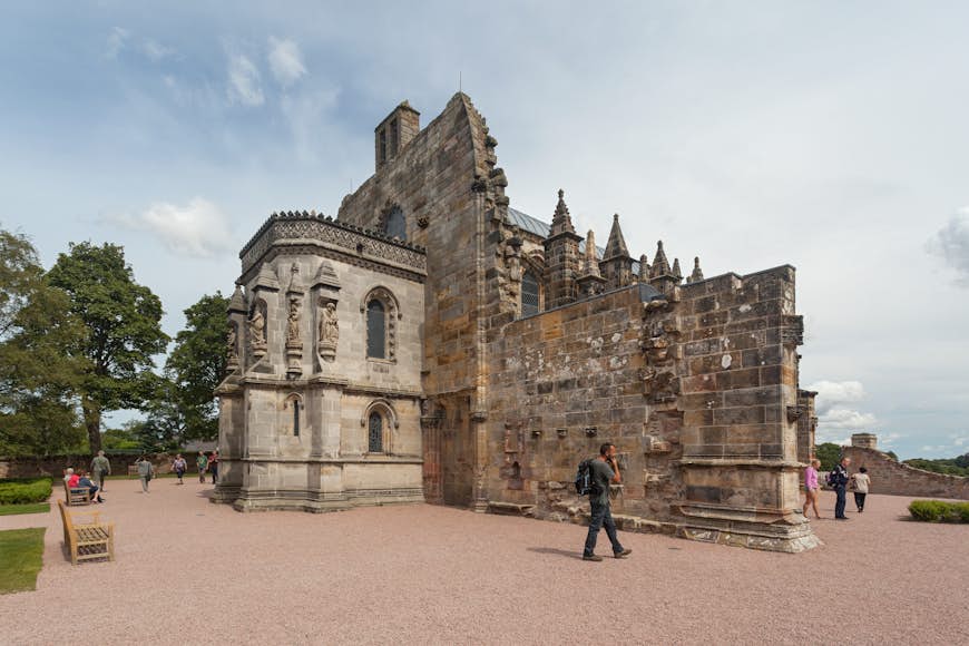 Tourist in front of Rosslyn chapel, one of most popular tourist attraction in Scotland