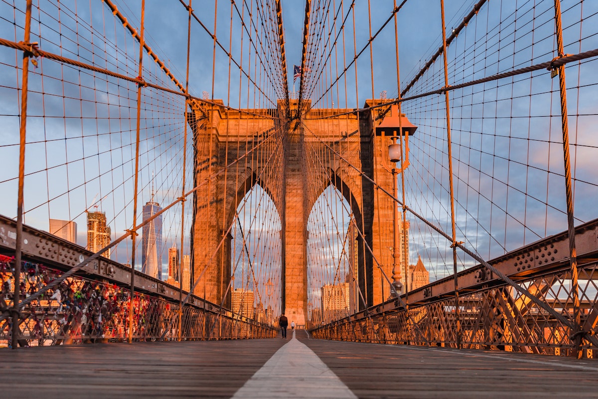 Visitors crossing the Brooklyn bridge during the early morning.