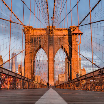 Visitors crossing the Brooklyn bridge during the early morning.