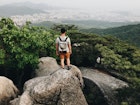 Young Man Hiking In Bukhansan National Park View Looking Out To The City Of Seoul South Korea

