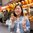 Women eating street food at market