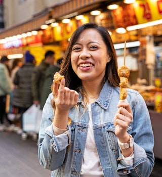 Women eating street food at market