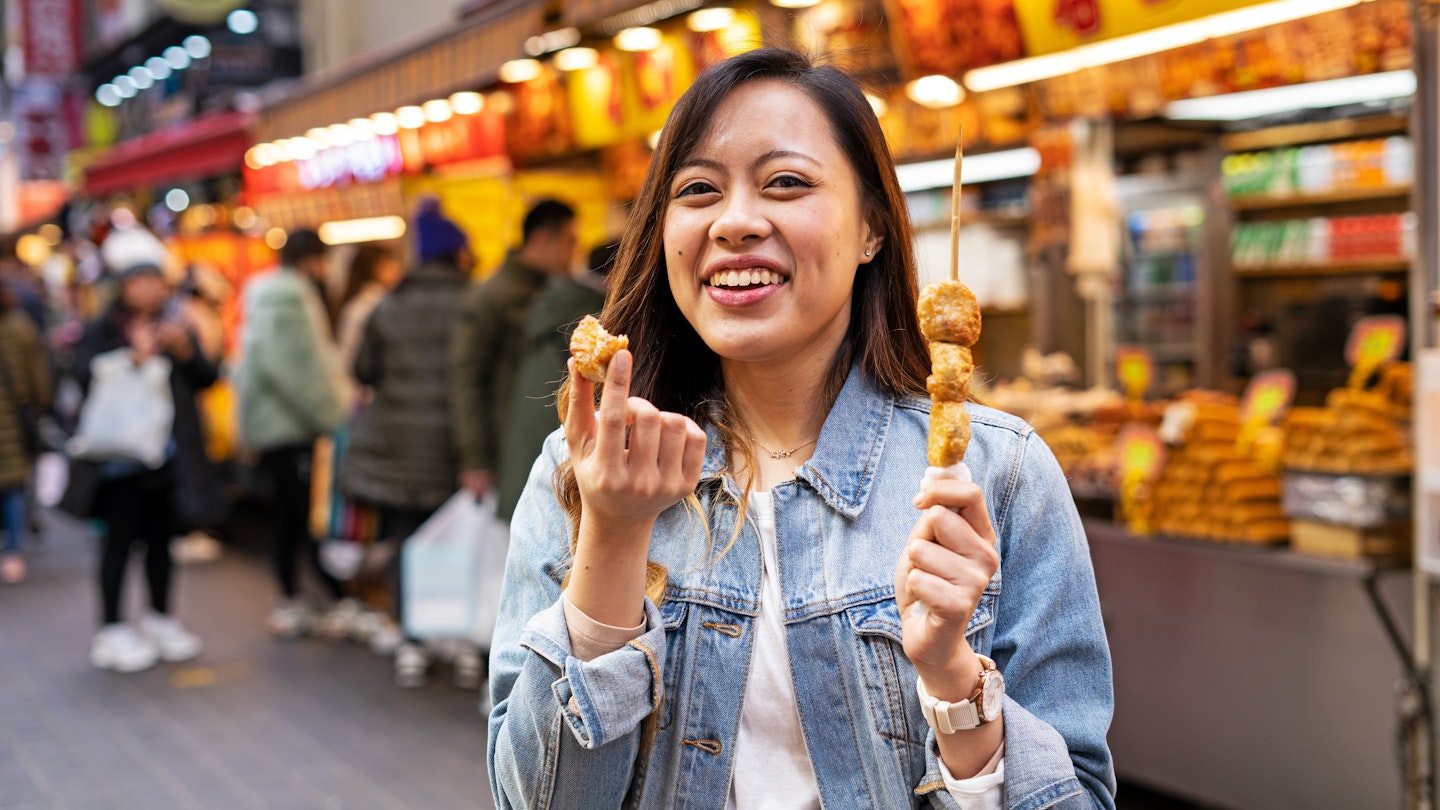 Women eating street food at market