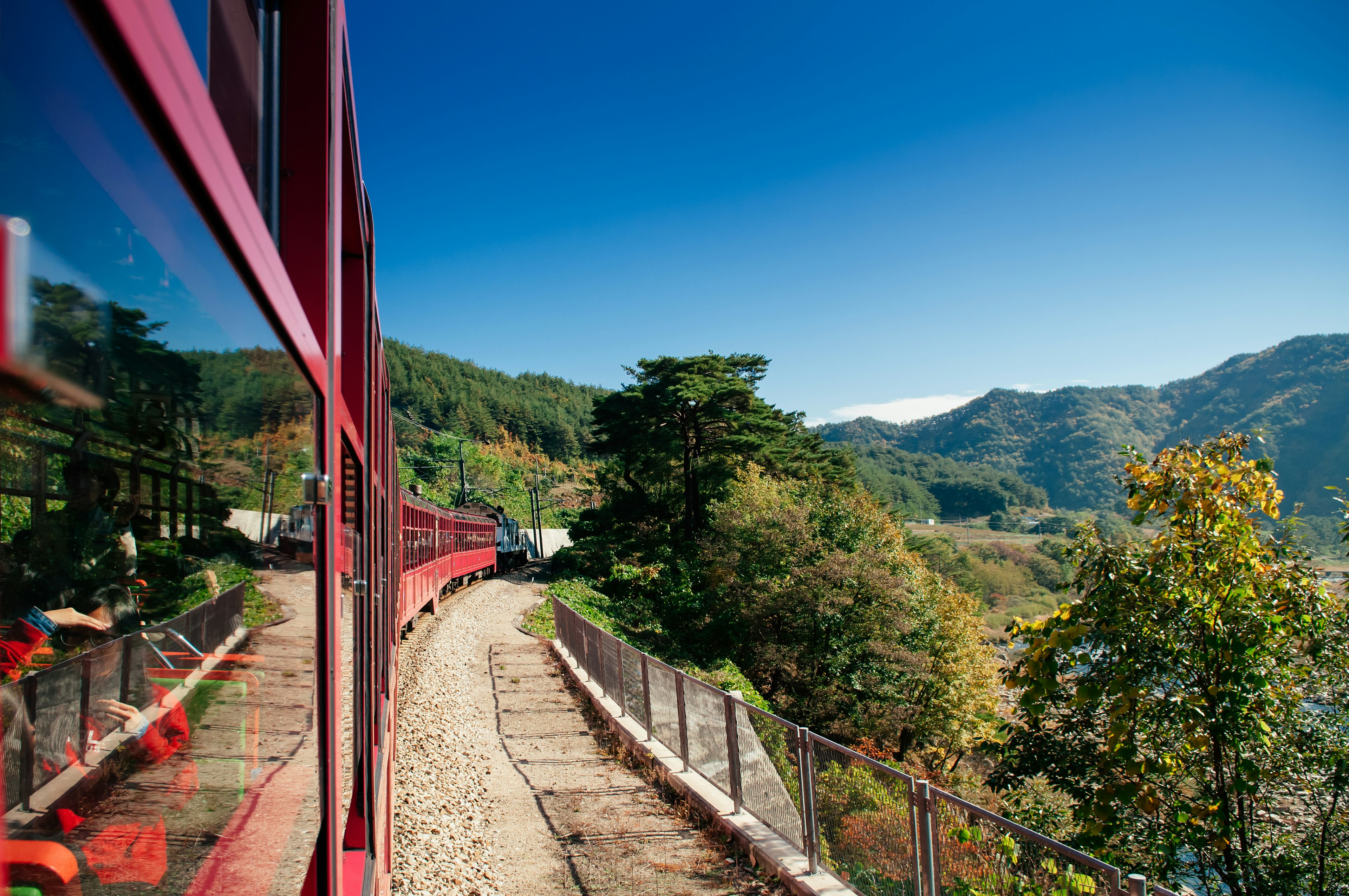 V-Train sightseeing train run along stream and valley, South Korea