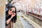 Young woman visiting Jinhae Gunhangje Cherry blossom Festival in South Korea.