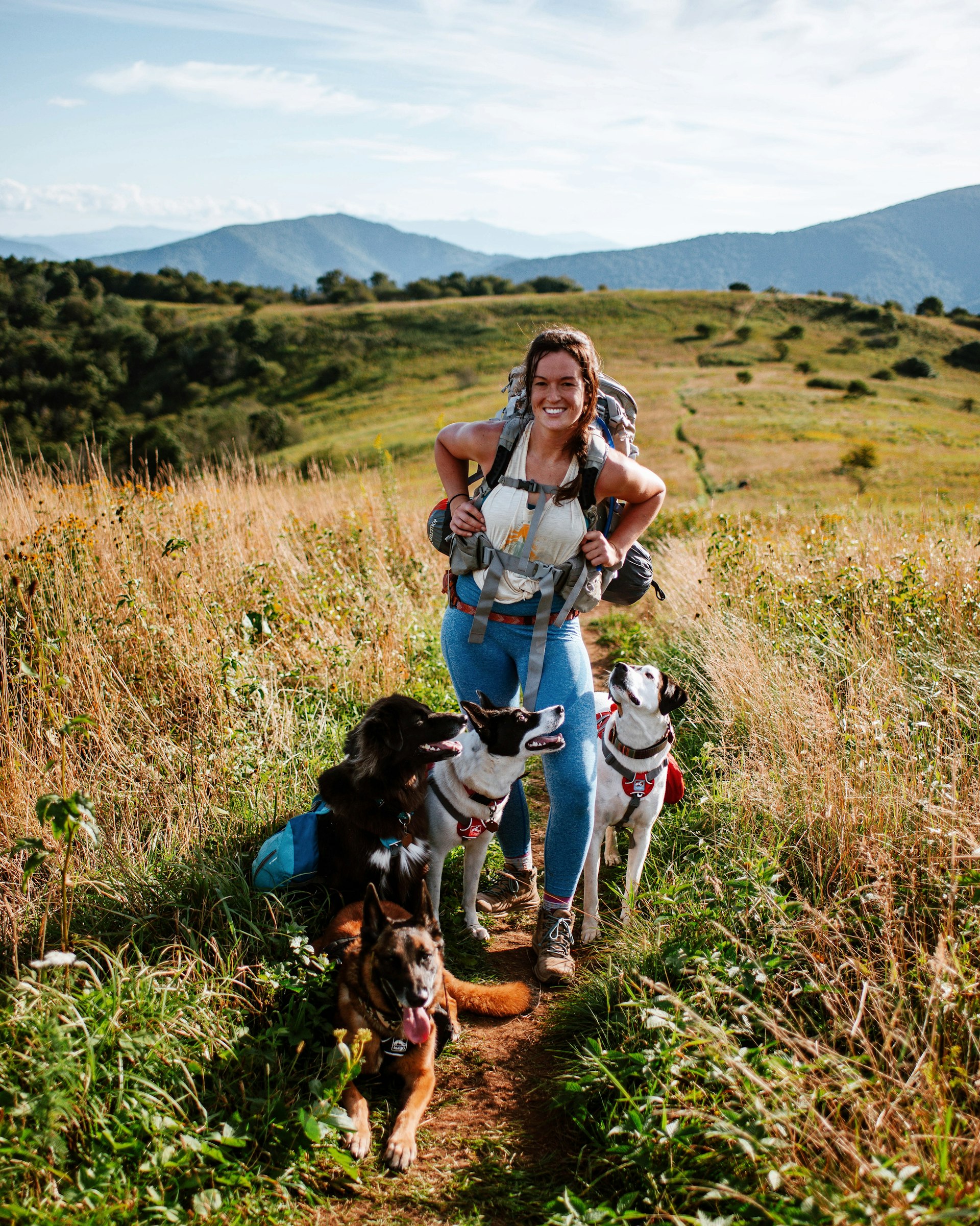 Happy Young Couple Hiking Together On A Summer Day by Stocksy