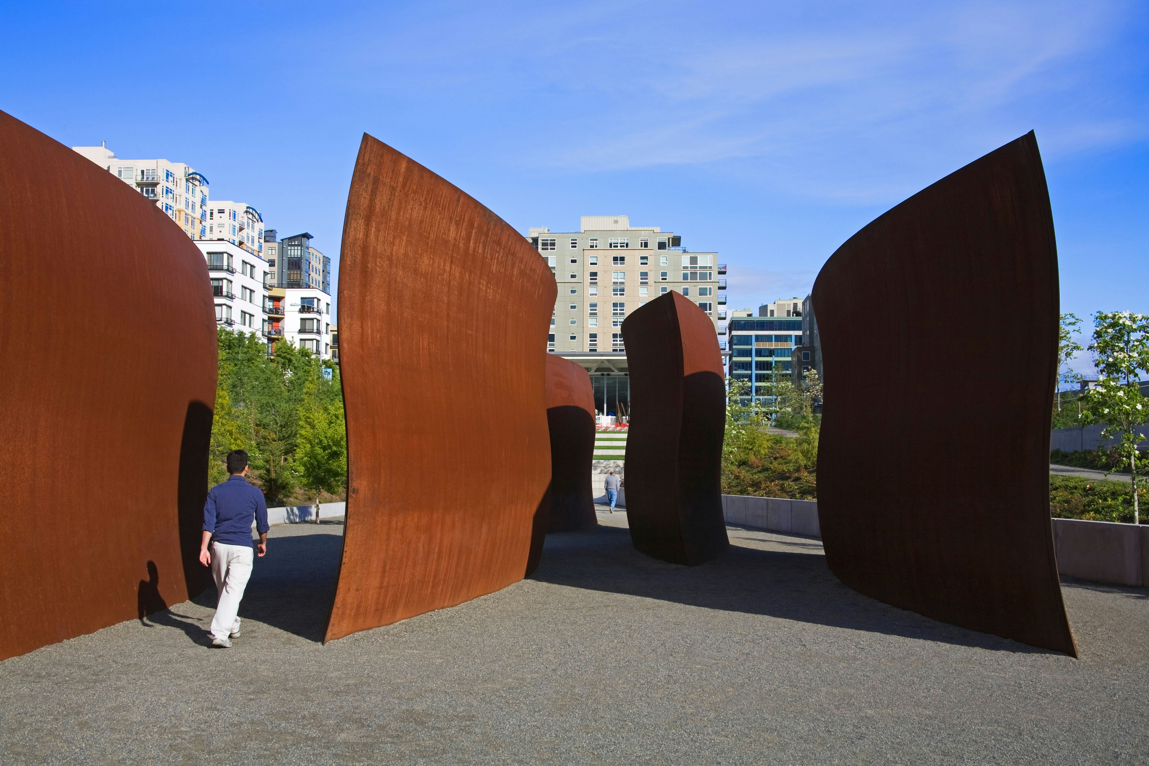 Person walking around sculptures at Olympic Sculpture Park in Seattle