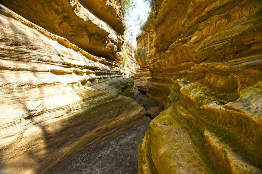 A narrow passageway weaves between sheer rock faces in Kenya