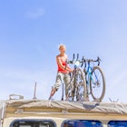 Helmeringhousen, Namibia - April 28, 2015: Young girl attaching bicycles on the roof of the truck in Namibia.