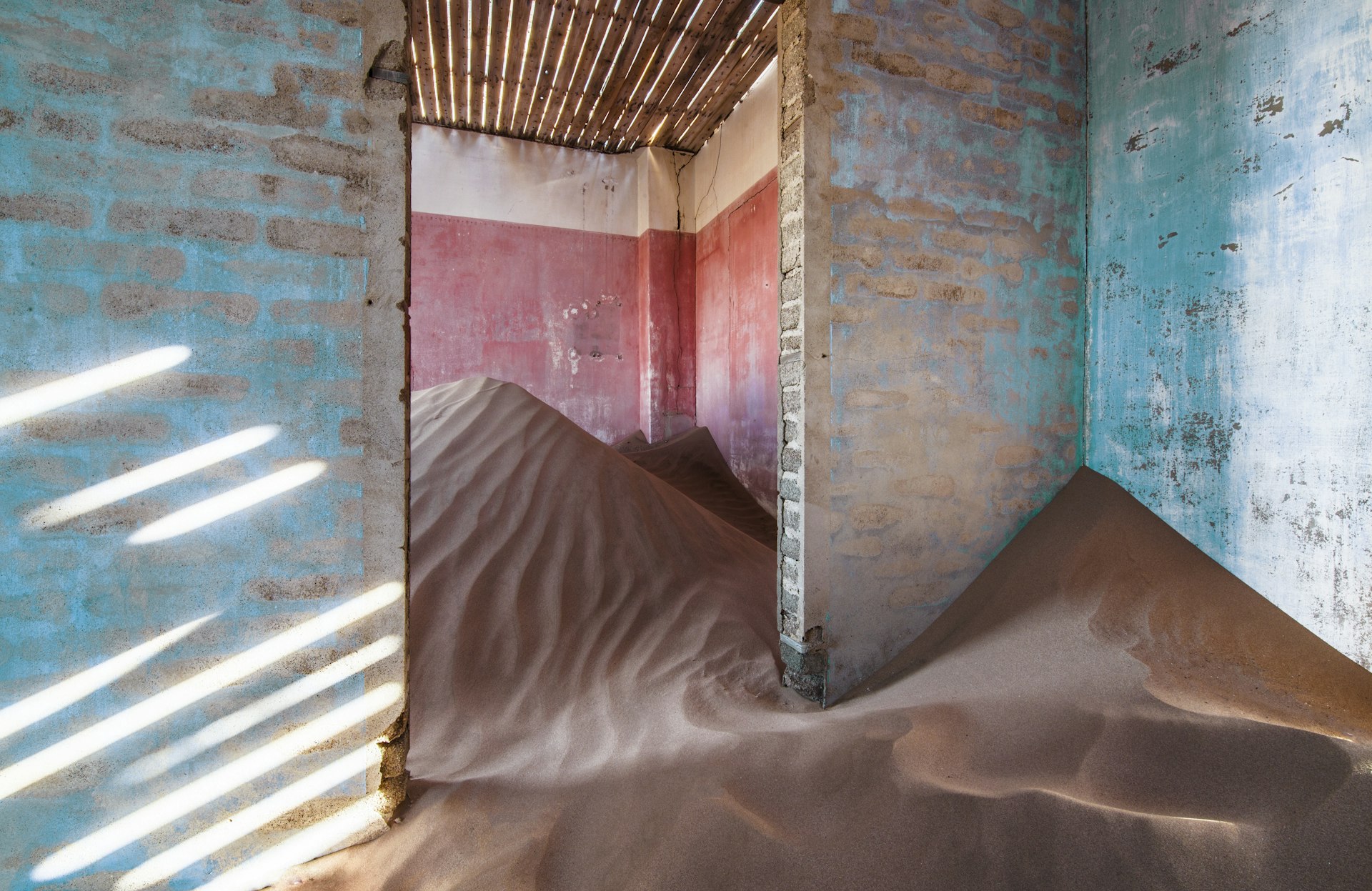 A sand dune has formed inside an abandoned building in a ghost town in Namibia