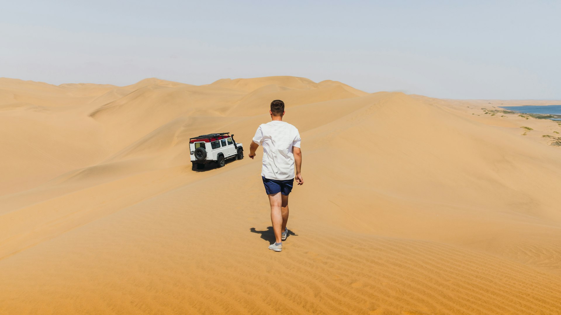 A man with a 4WD in the sand dunes of Sandwich Harbour, Namibia