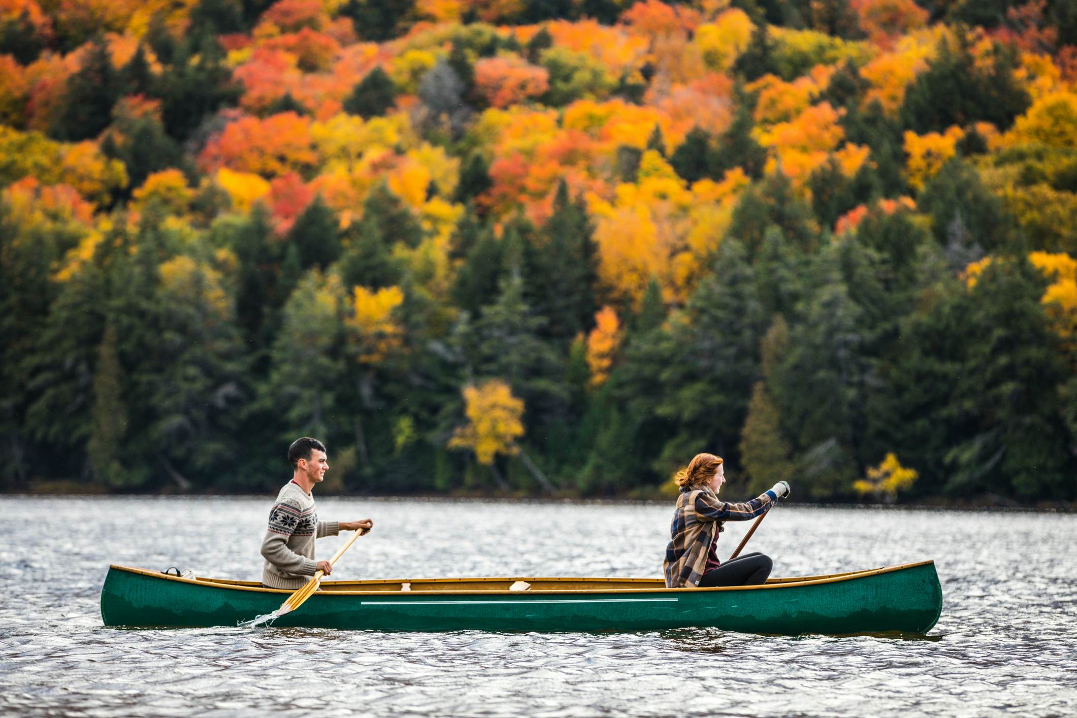 Couple enjoying a ride on a typical canoe in the Algonquin Park, Ontario - Canada.