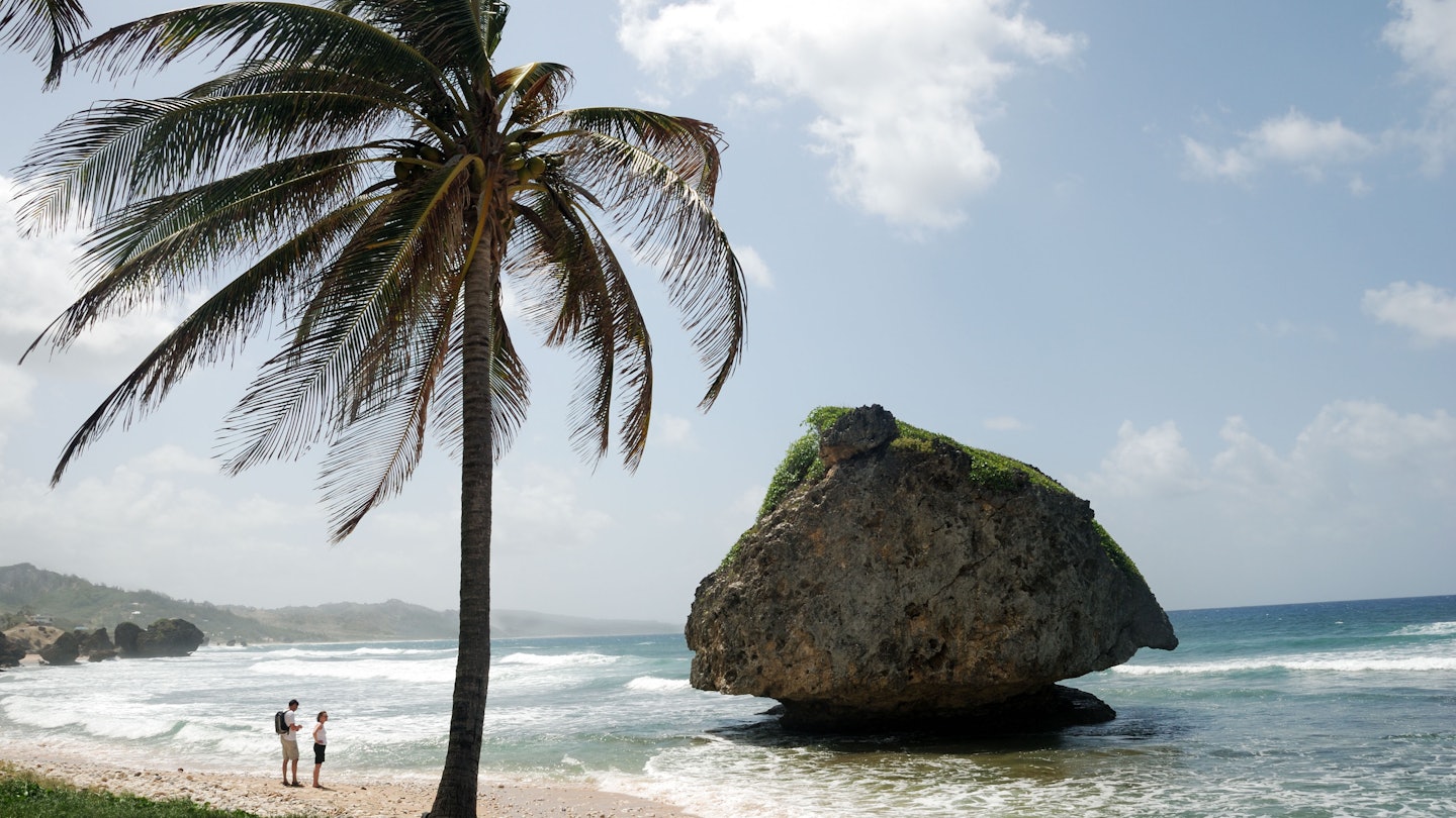 BWRYFM Two sightseers on coast at Bathsheba, Barbados, West Indies, Caribbean.