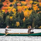 Couple enjoying a ride on a typical canoe in the Algonquin Park, Ontario - Canada.