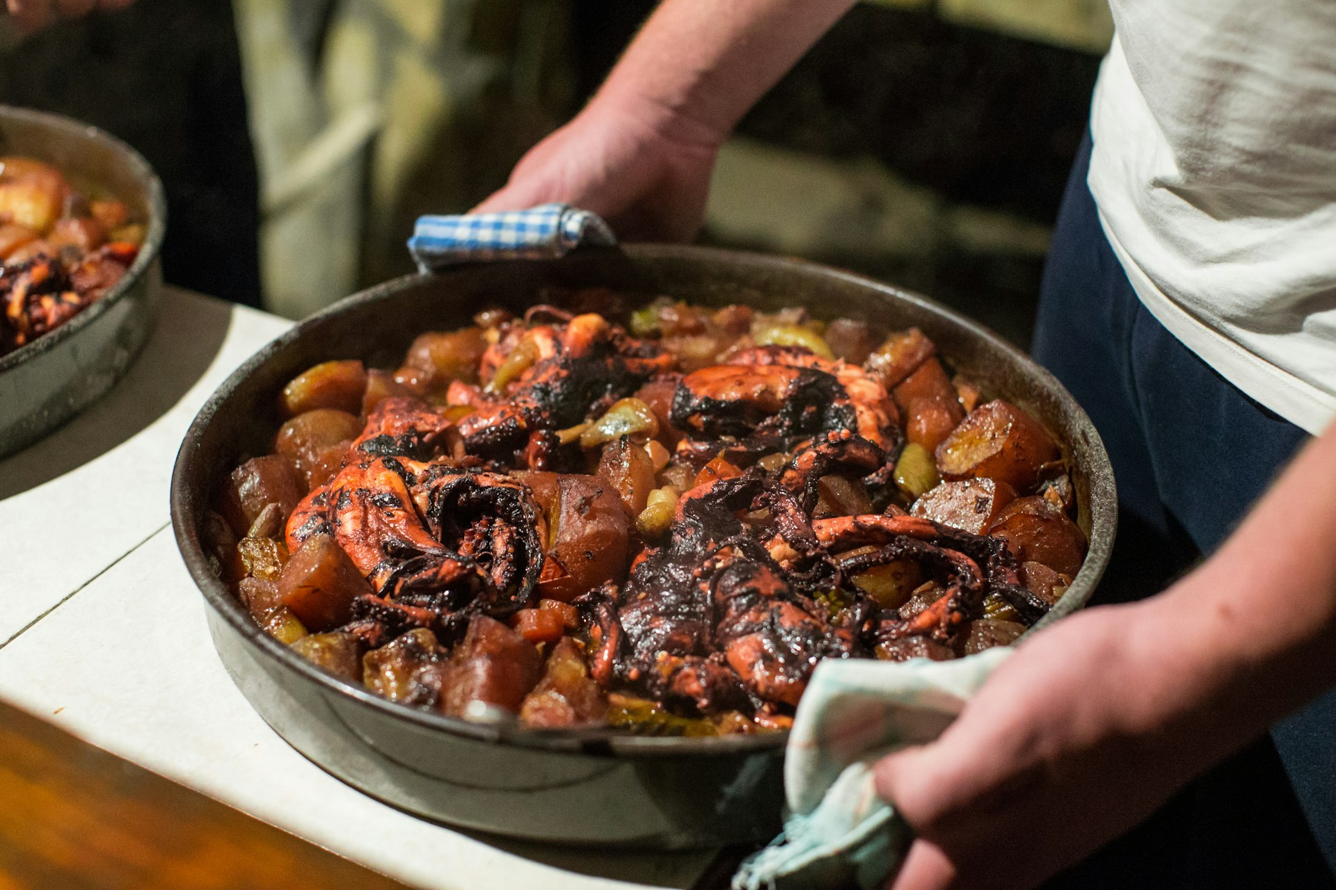 Large pot of peka, a traditional way of preparing food. The cast iron bell seals in flavours and juices as meat, octopus or vegetables cook for up to three hours on bed of charcoal