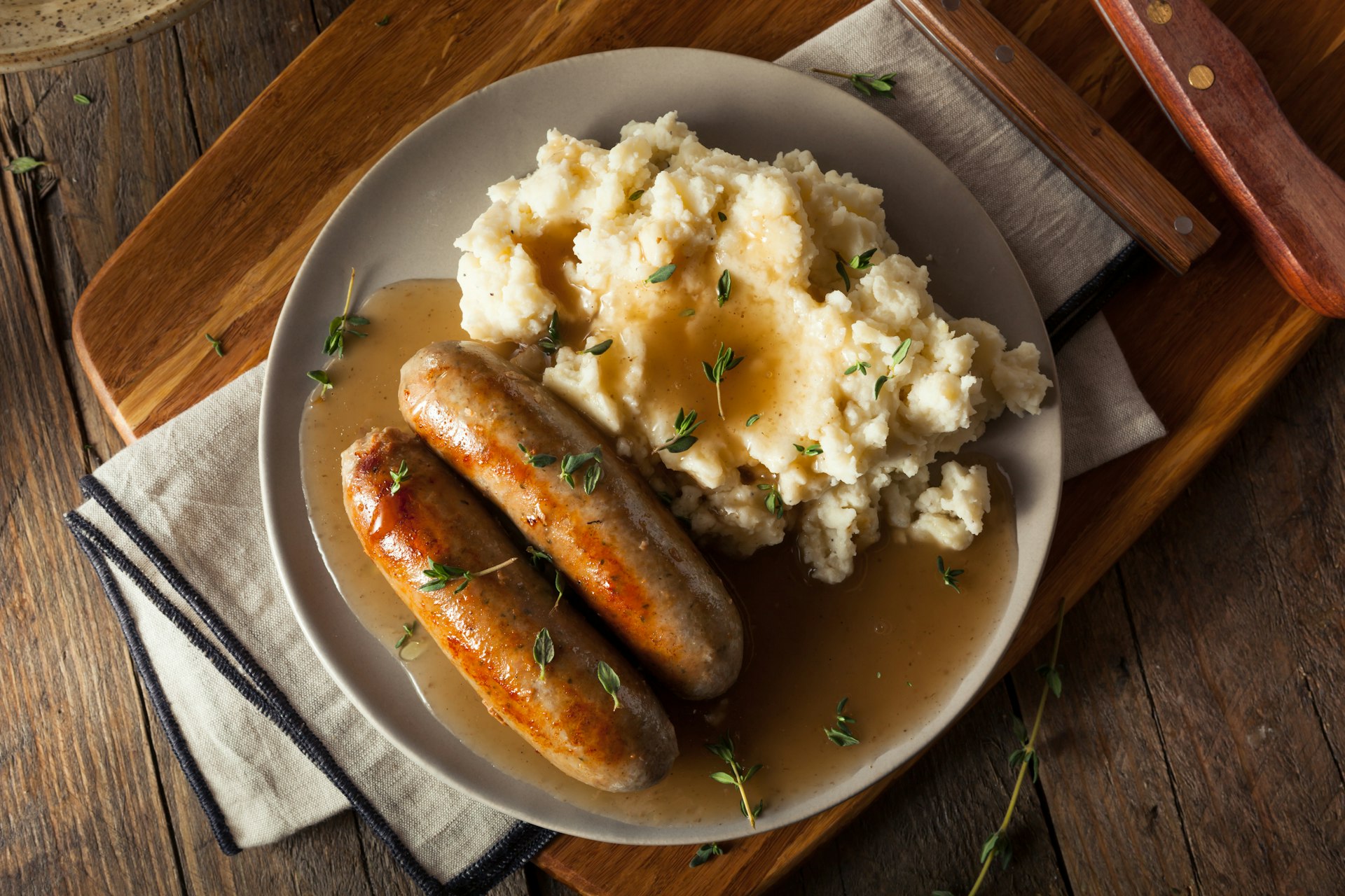 Homemade bangers and mash with herbs and gravy