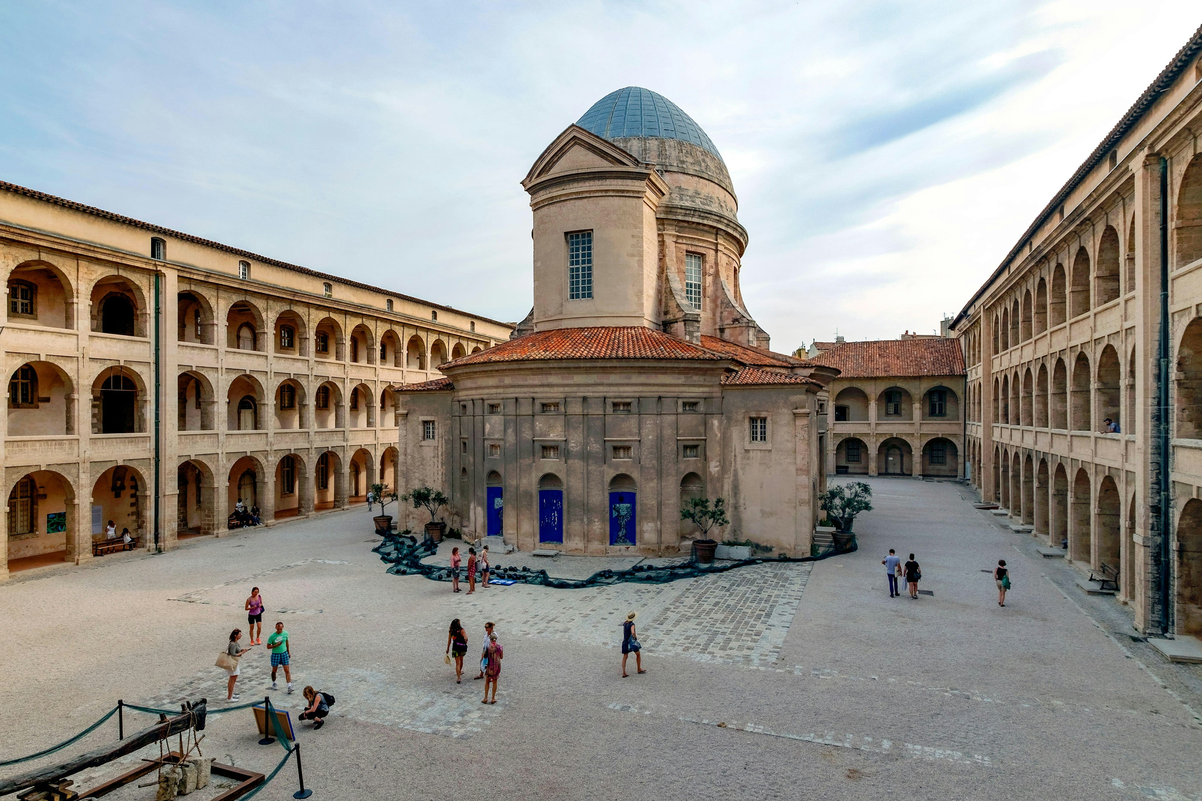 The exterior of a museum building with a large central domed section