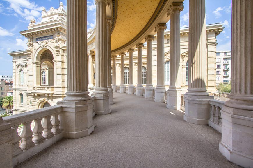 A grand arcaded pathway in a museum in Marseille