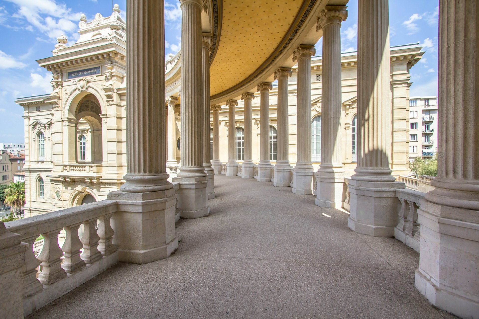 A grand arcaded pathway in a museum in Marseille