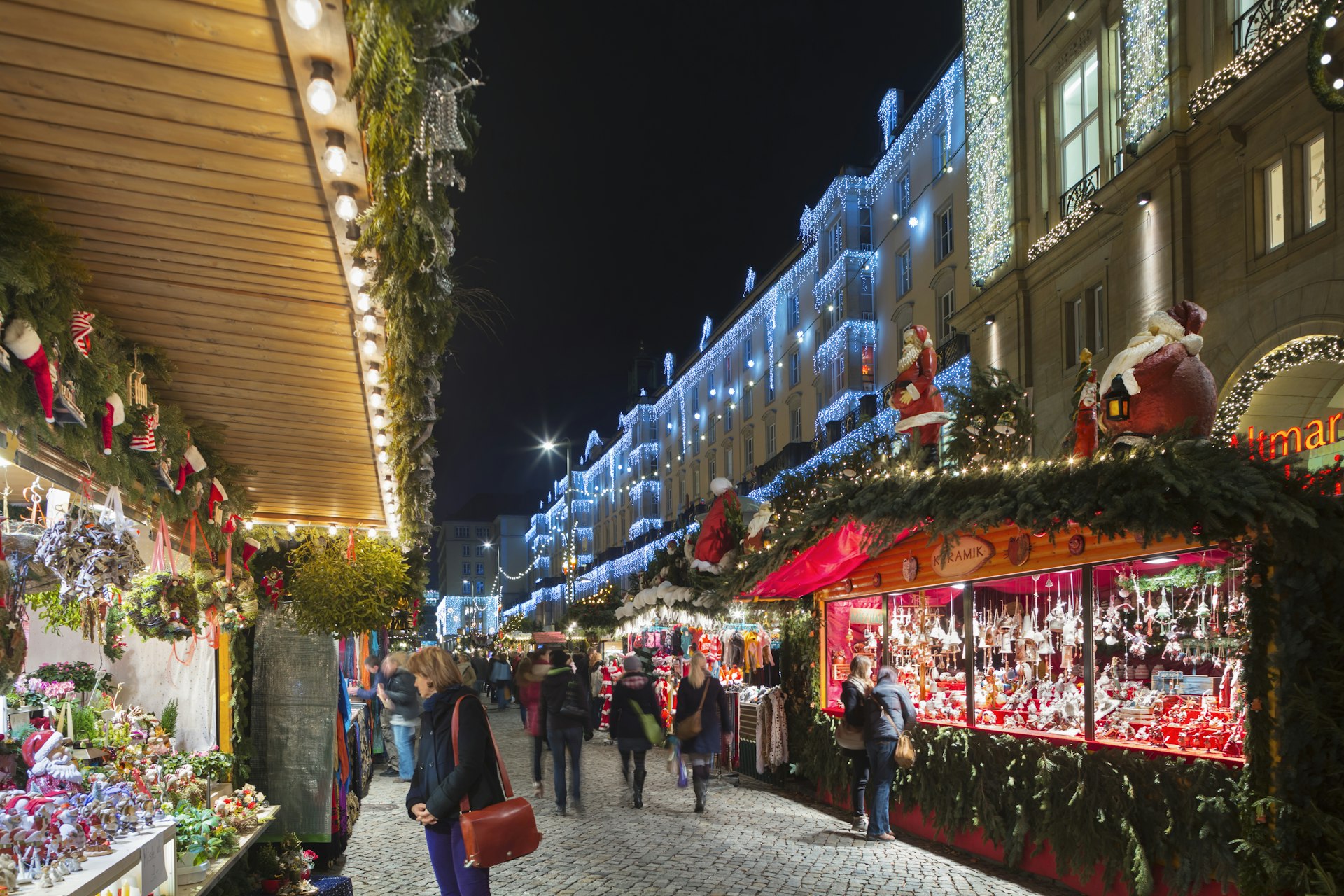 A street lined with wooden huts selling Christmas-themed items