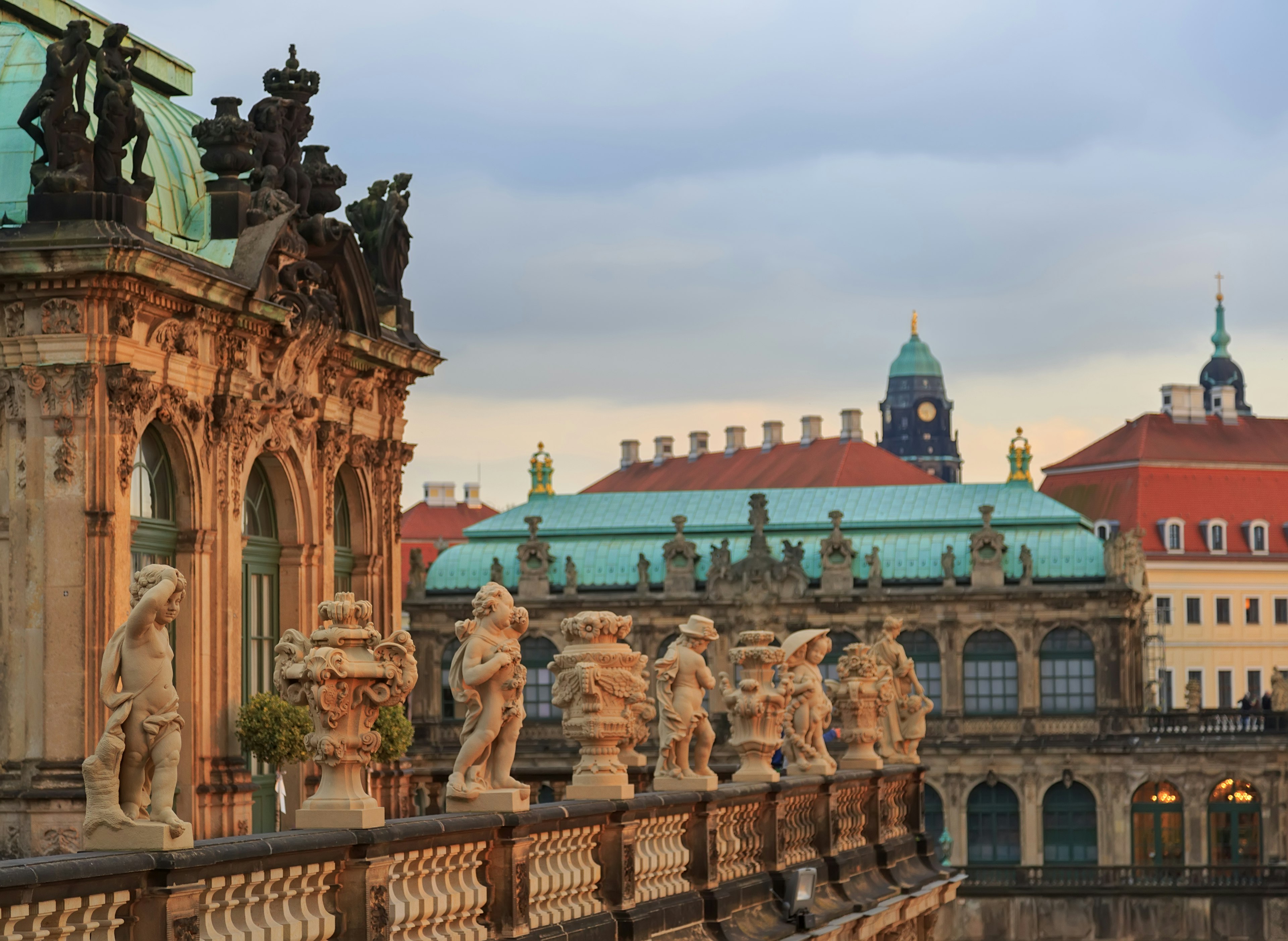 Rows of stone statues line the wall at the Zwinger