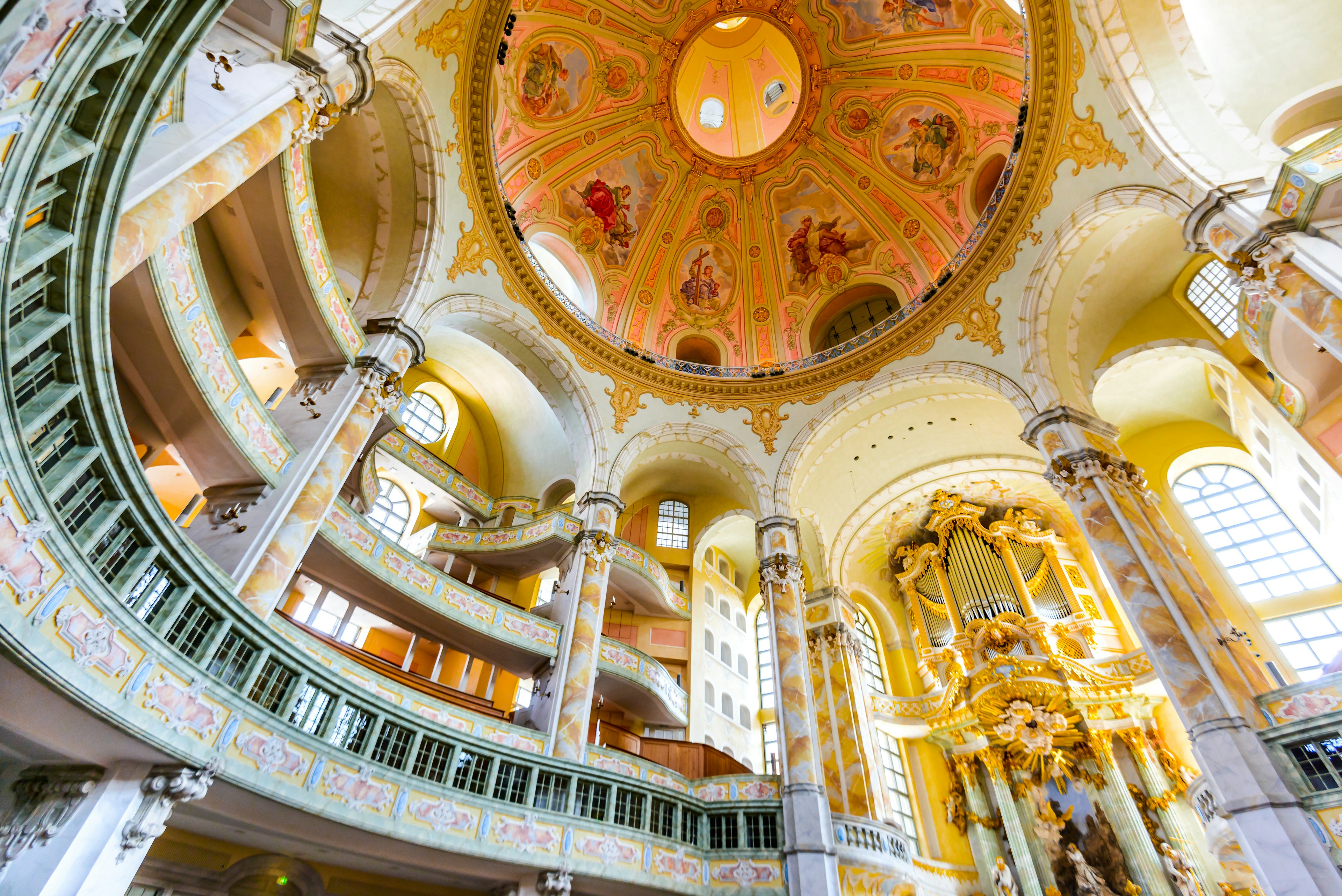 The interior of a domed building, looking upwards at the curved canopy of a cathedral