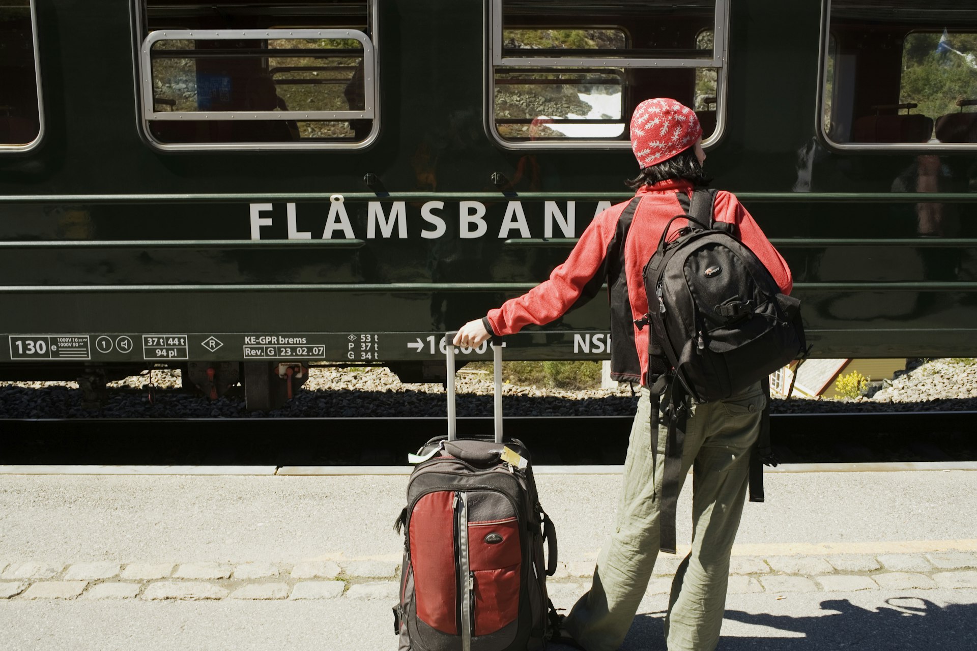 A backpacker waits to board the scenic Flamsbana Railway in Norway