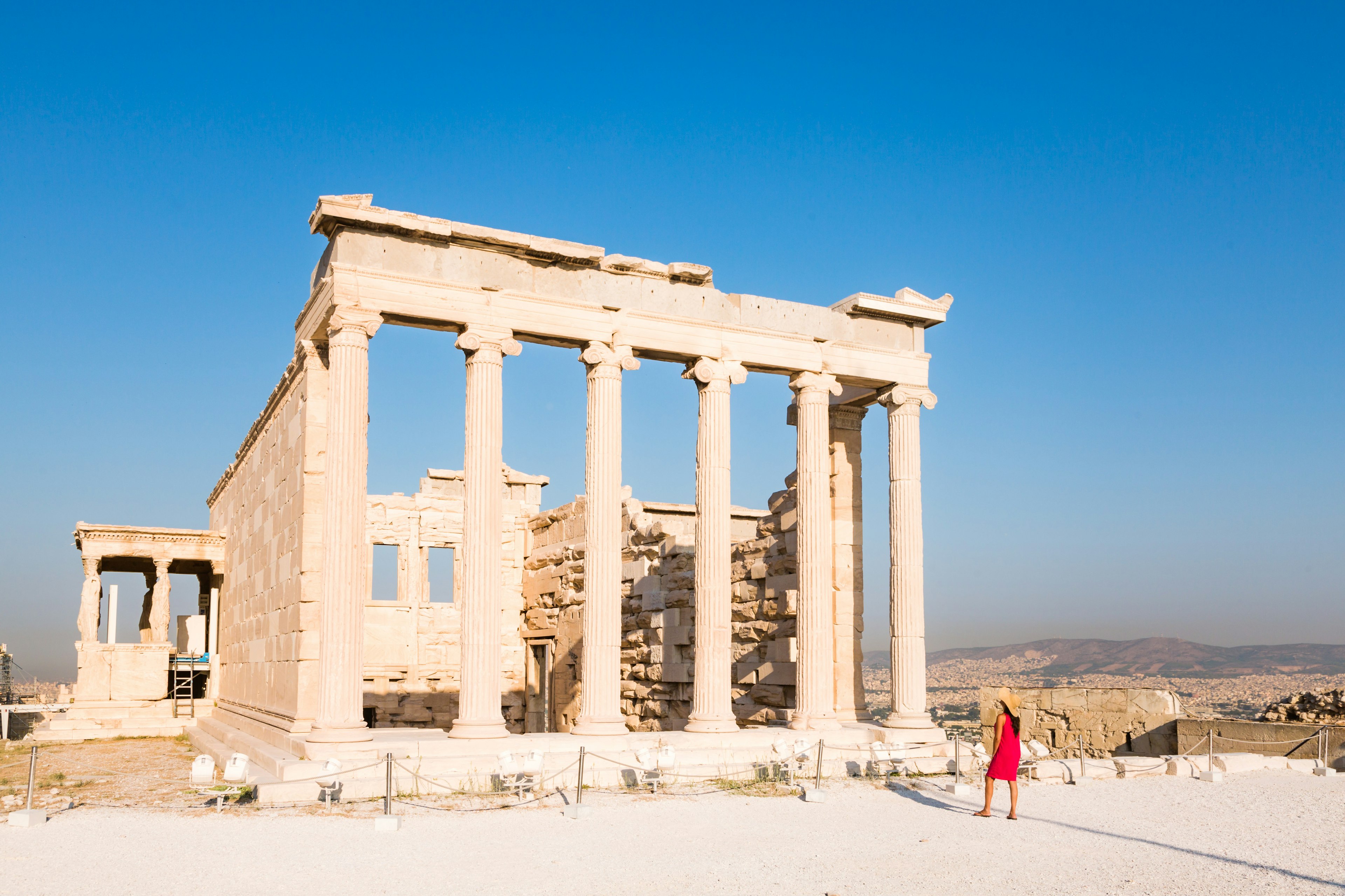 Woman looking at the ruins of a temple on the Acropolis, Athens, Greece